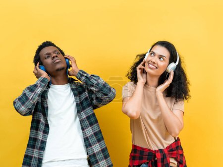 Photo for Young Couple Enjoying Music On Headphones Against Yellow Background, Leisure Lifestyle, Joyful Together, Casual Fashion, Modern Youth, Entertainment Concept - Royalty Free Image