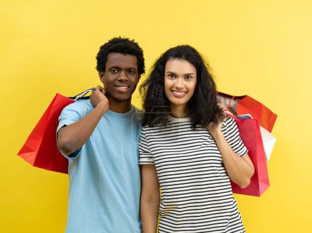 Photo for Shoppers Enjoying Retail Therapy, Cheerful Couple With Colorful Shopping Bags, Sale Season, Casual Fashion, Vibrant Yellow Background, Consumerism And Lifestyle Concept - Royalty Free Image