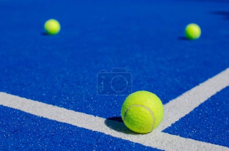 Foto de Enfoque selectivo, tres bolas en una pista de pádel azul - Imagen libre de derechos
