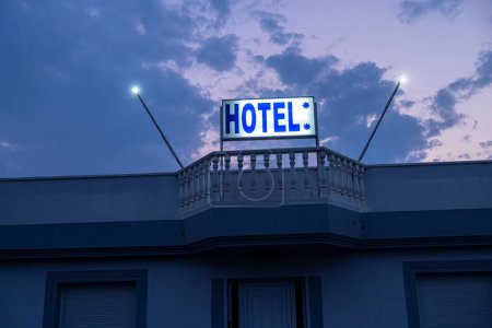 Photo for Roadside hotel sign illuminated at dusk - Royalty Free Image