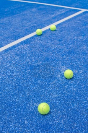 selektiver Fokus, mehrere Paddle-Tennisbälle auf einem blauen Kunstrasen-Paddle-Tennisplatz