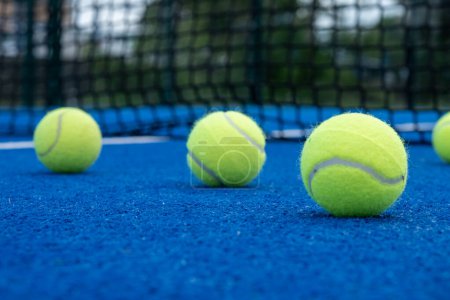 five balls on a paddle tennis court, selective focus,