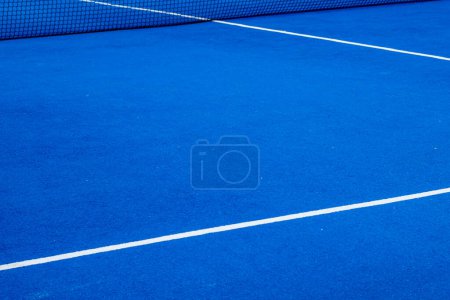 Blue paddle tennis court with artificial grass