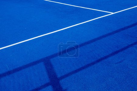 Blue paddle tennis court with artificial grass, racket sports concept