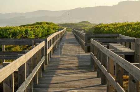 Wooden footbridge on a beach at sunrise