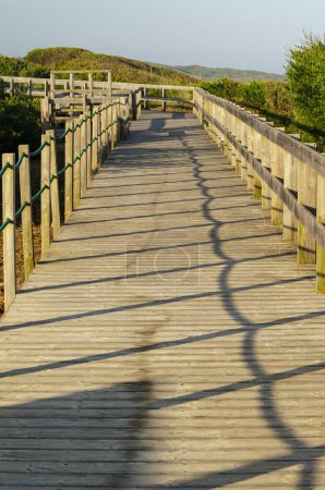 Wooden walkway on a beach at sunrise