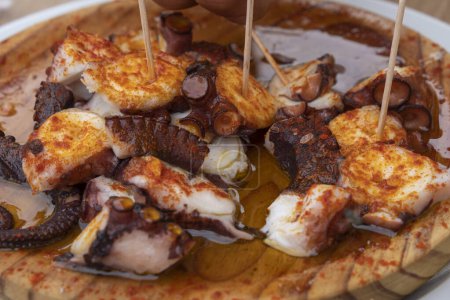 Photo for Pulpo a feira, typical Galician recipe for cooking octopus. Gastronomy in Galicia - Royalty Free Image