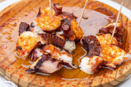 Photo for Ration of pulpo a feira, typical Galician recipe for cooking octopus. Gastronomy in Galicia - Royalty Free Image