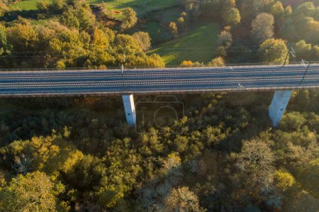 drone aerial view of a high speed rail viaduct at sunset