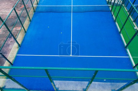 blue paddle tennis court aerial viewed by drone