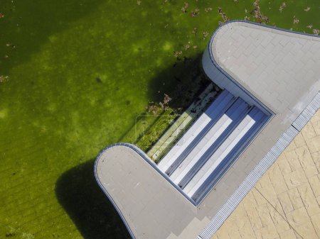 Photo for Aerial view of an abandoned swimming pool with dirty water - Royalty Free Image