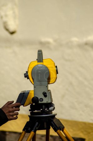Photo for An engineer's hand using a total station for topographic measurements. - Royalty Free Image