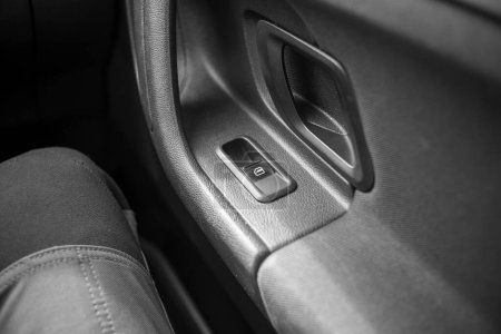 detail of the front passenger door of a car, black and white