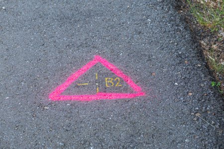 Photo for Topography marking painted on a road, pink geodetic mark on the asphalt - Royalty Free Image