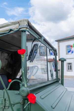 two red carnations decorating a military vehicle during the commemoration of April 25th in Portugal. Revoluaco dos Cravos.