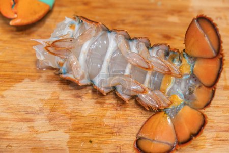 Photo for Fresh lobster tail on wooden board, close-up. gourmet ingredient - Royalty Free Image