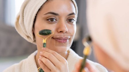 Photo for Beauty, skin care and people concept - smiling young woman in skin care and looking to mirror at home bathroom - Royalty Free Image