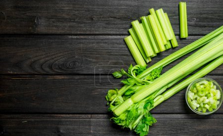 Photo for Fresh juicy celery in a bowl. On wooden background - Royalty Free Image