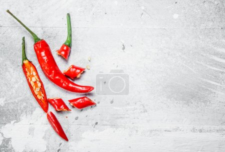 Pieces of hot red pepper. On white rustic background