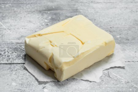 Photo for Butter on paper. On a rustic background. - Royalty Free Image