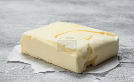 Photo for Butter on paper. On a rustic background. - Royalty Free Image