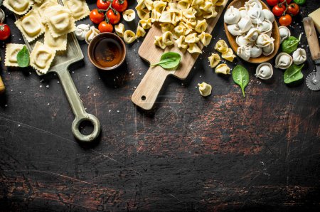 Photo for Different kinds of traditional Italian raw pasta. On dark rustic background - Royalty Free Image