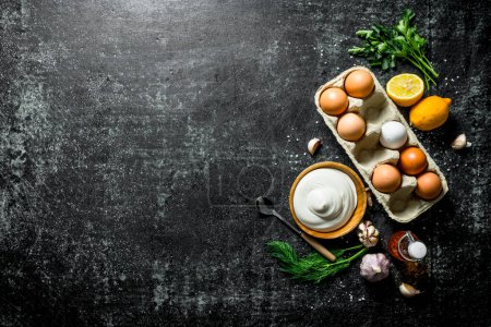 Mayonnaise with eggs, herbs and garlic. On dark rustic background
