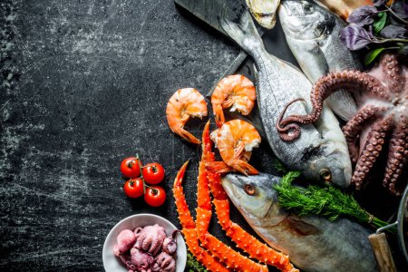 Assortment of fresh seafood. On dark rustic background