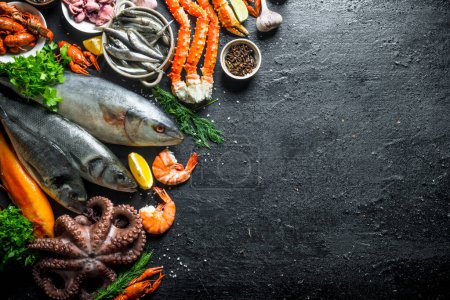 Téléchargez les photos : Variété de fruits de mer frais. Sur fond rustique noir - en image libre de droit