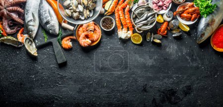 frischer Fisch und Meeresfrüchte. auf schwarzem rustikalem Hintergrund