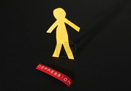 Photo for Paper cutout person with red Depression label on dark background - Royalty Free Image