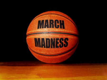 March Madness basketball on a hardwood court, college basketball tournament concept