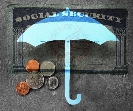Coins under a Social Security card and  paper umbrella -- financial security or retirement savings concept                               