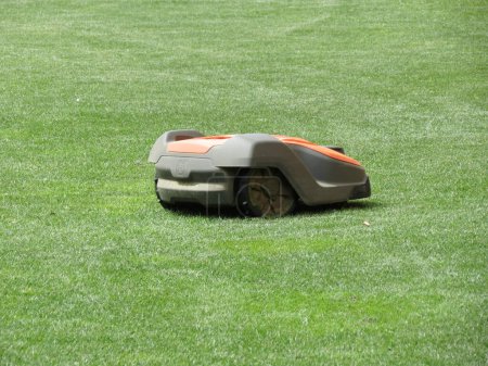 Photo for STOCKHOLM, SWEDEN - CIRCA APRIL 2022: unmanned Husqvarna Automower mowing the lawn - Royalty Free Image