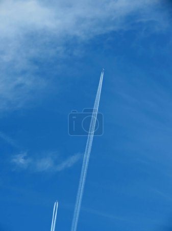 Photo for Two aircrafts leaving condensation tracks in the sky - Royalty Free Image