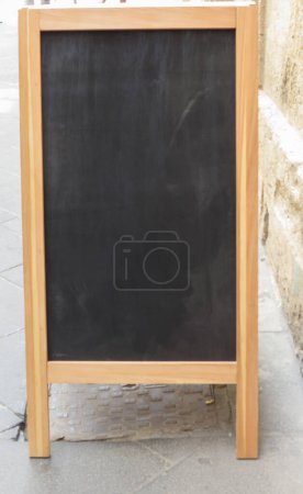 blank blackbord outdoors in front of a restaurant