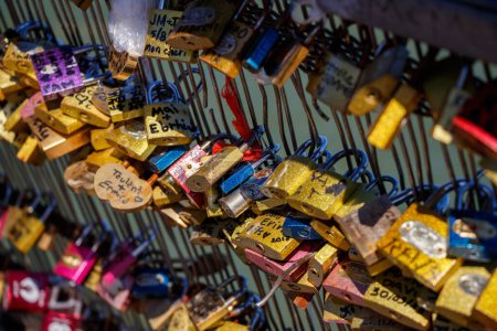 Photo for Engraved and Marked Locks hanging in the Pot Des Arts or Inlove ones Bridge - Royalty Free Image