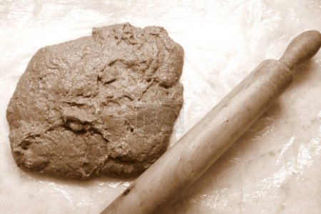 Téléchargez les photos : Cocoa flavored dough ready to be stretched, in sepia tones - en image libre de droit