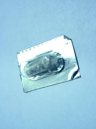 Photo for Contrast pill for digestive tract image study in its blister, in light blue and sepia tones - Royalty Free Image