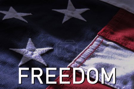 Téléchargez les photos : Freedom: The word over closeup of an American flag - en image libre de droit
