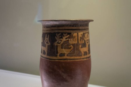 Photo for Ancient indigenous deeer ornament into a ceramic vase at colombian museum - Royalty Free Image