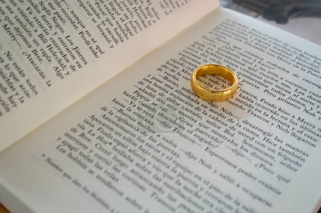 Photo for Spanish text book page of the lord of the rings the fellowship of the ring with the ring of power selective focus over the pages - Royalty Free Image