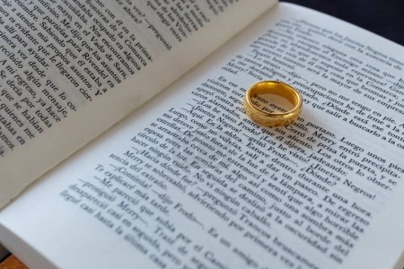 Photo for The one ring of the lord of the rings history in selective focus over the fellowship of the ring book in spanish - Royalty Free Image