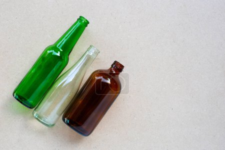Glass bottles on brown background. Copy space