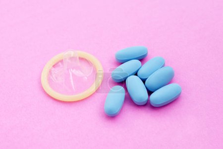 Photo for PrEP ( Pre-Exposure Prophylaxis) blue pills used to prevent HIV Blue pills with condom - Royalty Free Image