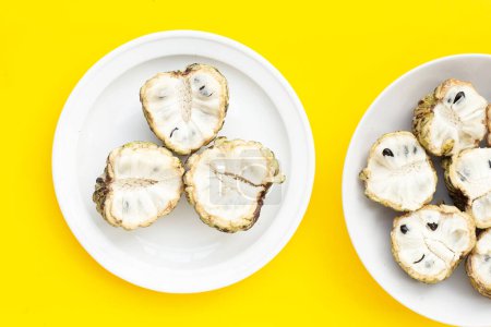Photo for Custard apple in white plate on yellow background. - Royalty Free Image