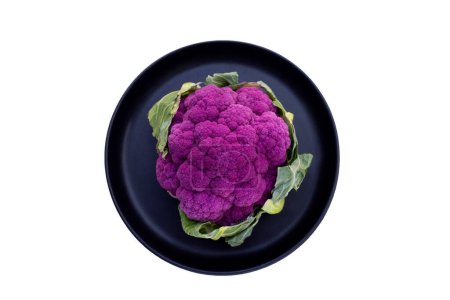 Photo for Purple cauliflower on dark plate on white background. - Royalty Free Image