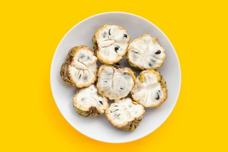 Photo for Custard apple in white plate on yellow background. - Royalty Free Image
