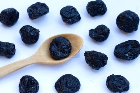 Dried prunes on white background