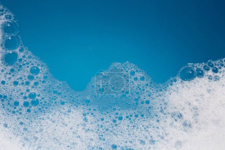Detergent foam bubble on water. Blue background, Soap sud-stock-photo